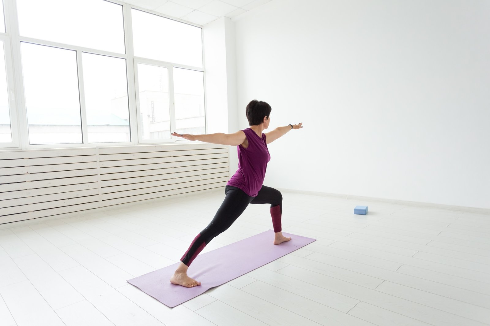 Yoga, people concept - a middle-aged woman doing a yoga and try to do a asana